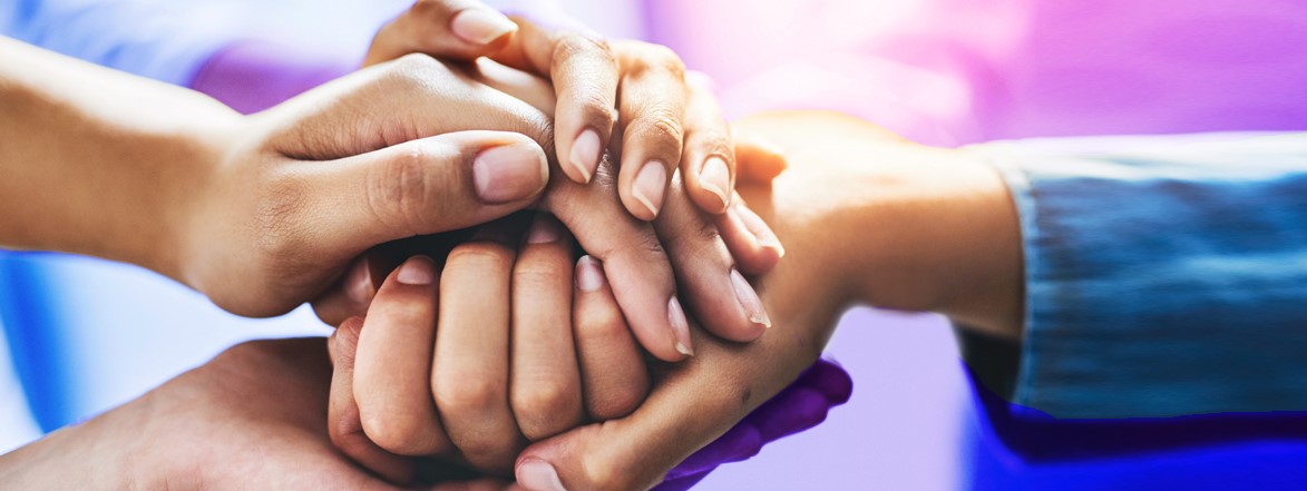 team members with hands stacked together